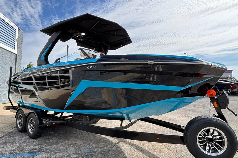 Slide: The Image of 2026 Tigé Z3 boat with sleek black and blue design on a trailer. - 6