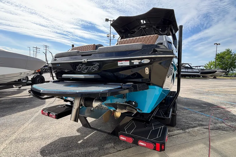 Slide: The Image of 2026 Tigé Z3 boat with sleek design, parked outdoors under a partly cloudy sky. - 7