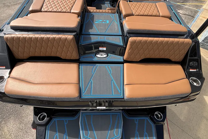 Slide: The Image of 2026 Tigé Z3 boat interior with tan quilted seats and blue-accented flooring. - 9