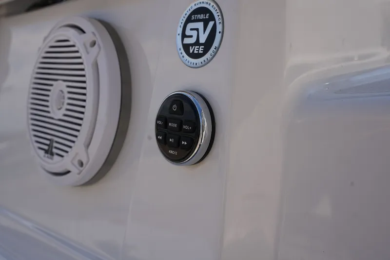 Slide: The Image of Speaker and control panel on a 2019 Four Winns H230 boat. - 12