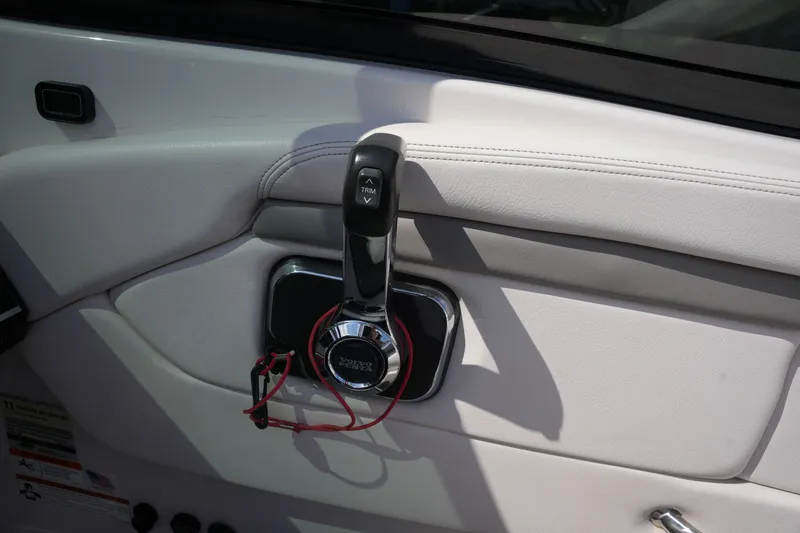 Slide: The Image of Interior view of a 2019 Four Winns H230 boat with throttle lever. - 31
