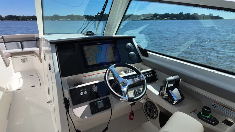 Slide: The Image of The cockpit of the 2027 Boston Whaler 330 Vantage with modern steering and navigation system. - 21