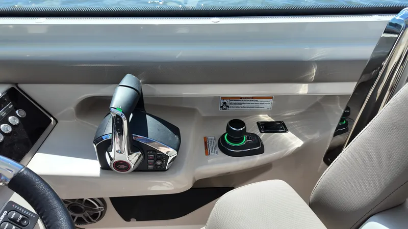 Slide: The Image of The image shows the helm of a 2027 Boston Whaler 330 Vantage with modern controls. - 22