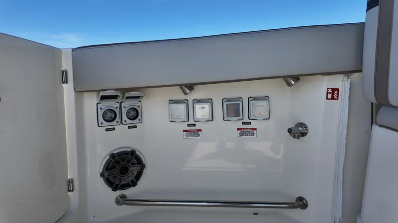 Slide: The Image of The image shows the control panel of a Boston Whaler 330 Vantage boat with various switches and speakers. - 11