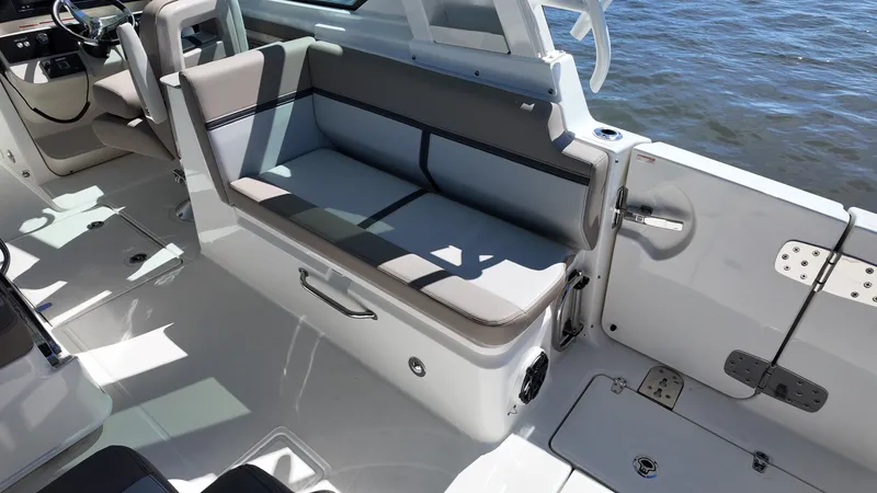 Slide: The Image of The 2027 Boston Whaler 330 Vantage features a sleek bench seat and modern cockpit design. - 15
