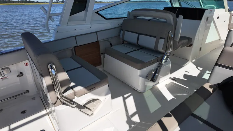 Slide: The Image of The image shows the cockpit of a 2027 Boston Whaler 330 Vantage with gray upholstery. - 16