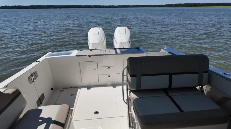 Slide: The Image of The image shows the stern of a 2027 Boston Whaler 330 Vantage boat with twin engines. - 8