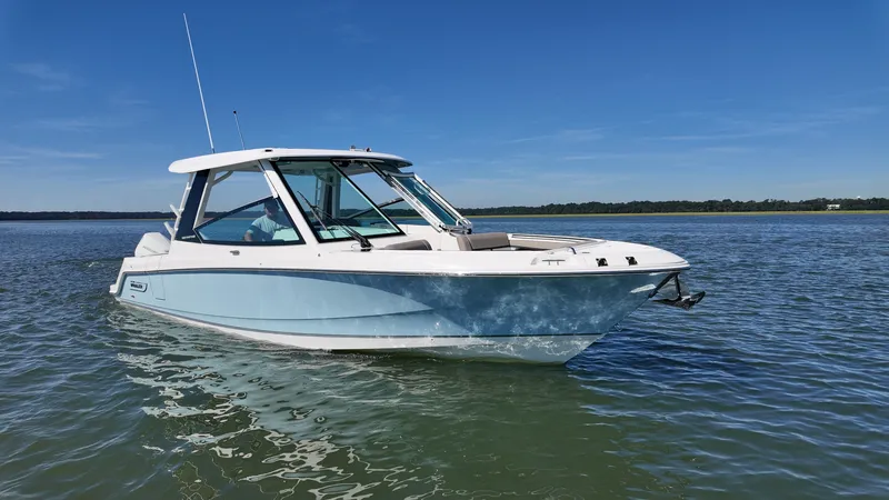 Slide: The Image of A 2027 Boston Whaler 330 Vantage on calm water with a clear sky. - 31