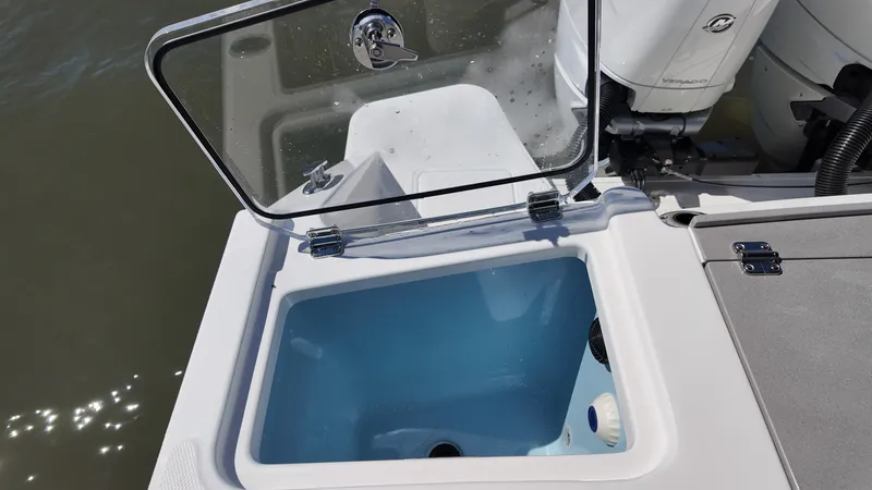 Slide: The Image of An open compartment on a Boston Whaler 330 Vantage boat reveals a blue interior. - 7