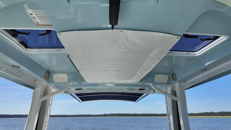 Slide: The Image of The image shows the roof of a Boston Whaler 330 Vantage boat with blue trim. - 24