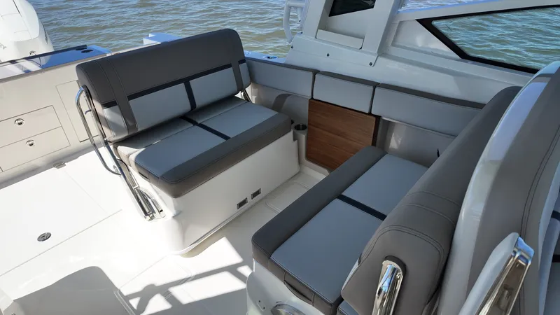 Slide: The Image of The 2027 Boston Whaler 330 Vantage features a stylish seating area with gray upholstery. - 17