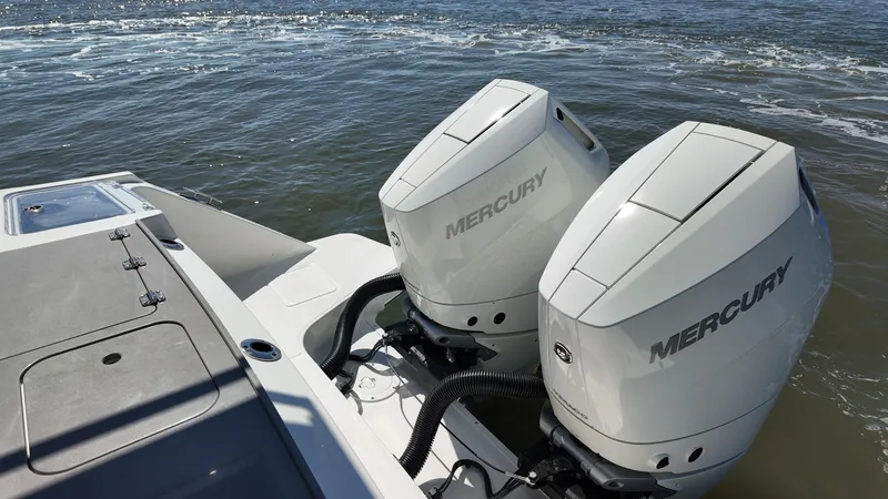 Slide: The Image of Two Mercury outboard engines on a Boston Whaler 330 Vantage on the water. - 5