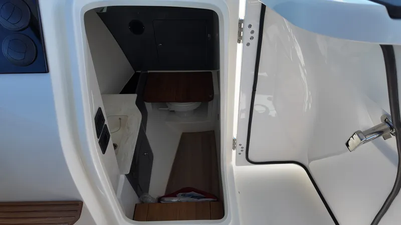 Slide: The Image of Interior view of a boat cabin with a toilet and sink. - 20