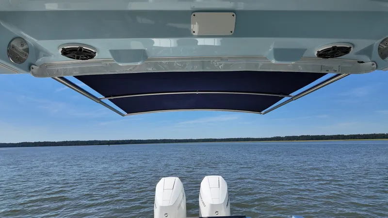 Slide: The Image of The image shows the stern of a 2027 Boston Whaler 330 Vantage with two engines and a blue sunshade. - 6