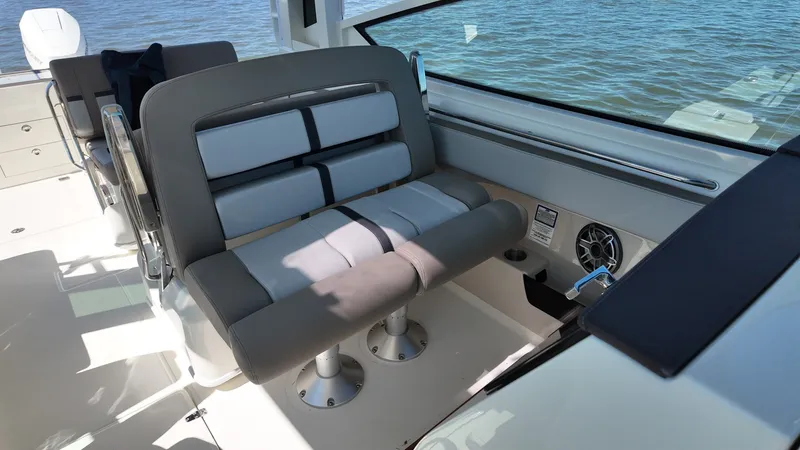 Slide: The Image of The 2027 Boston Whaler 330 Vantage features a comfortable bench seat overlooking the water. - 19