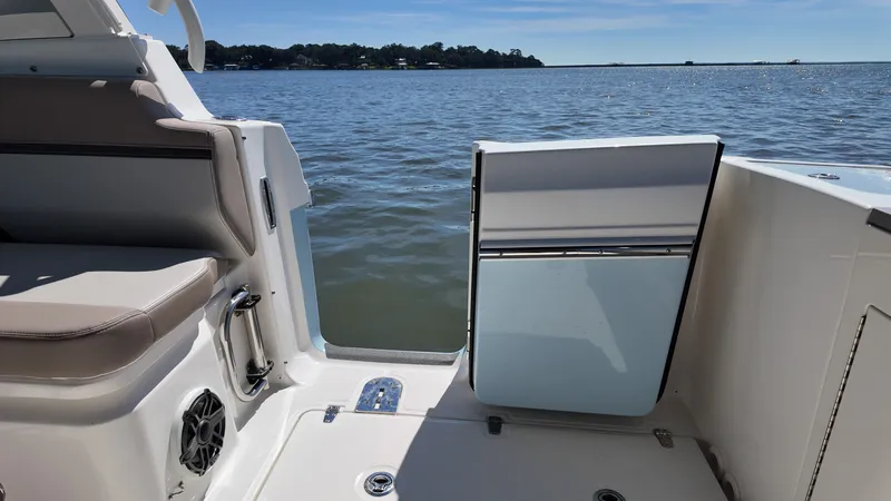 Slide: The Image of The image shows the stern of a Boston Whaler 330 Vantage boat overlooking the water. - 14
