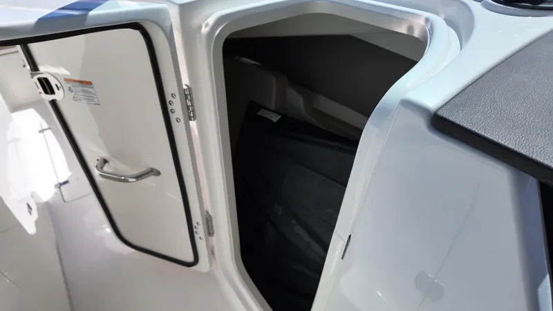 Slide: The Image of An open storage compartment on a Boston Whaler 330 Vantage boat, revealing a spacious interior. - 23