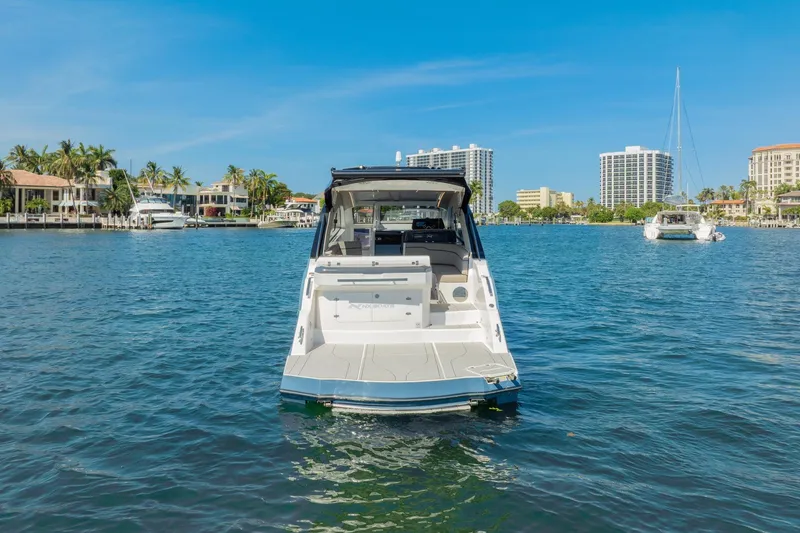 Slide: The Image of 2025 NX Boats NX41 HORIZON on serene water with cityscape background. - 13