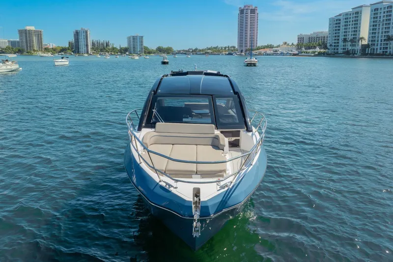 Slide: The Image of 2025 NX Boats NX41 HORIZON cruising on a sunny day in a bustling marina. - 14