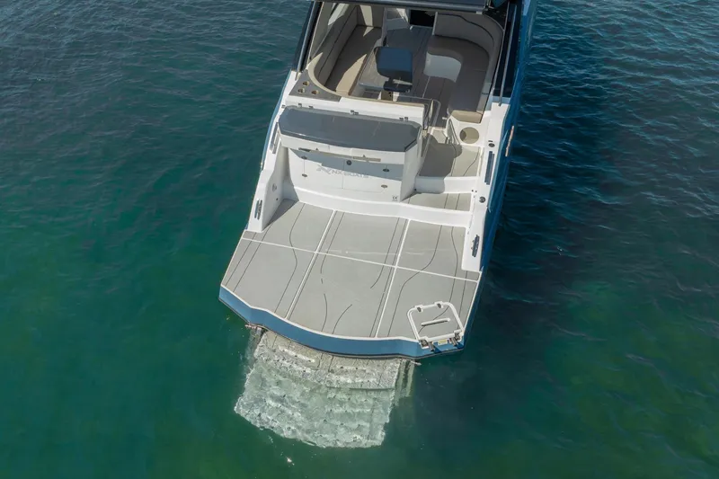 Slide: The Image of 2025 NX Boats NX41 HORIZON yacht on calm water, showcasing spacious deck design. - 22