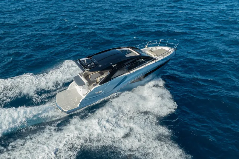 Slide: The Image of 2025 NX Boats NX41 HORIZON cruising on open blue sea, showcasing sleek design and performance. - 25