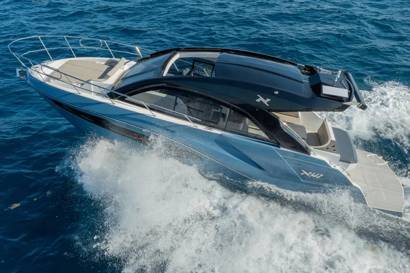 Slide: The Image of 2025 NX Boats NX41 HORIZON cruising on open sea, showcasing sleek design and luxury features. - 26