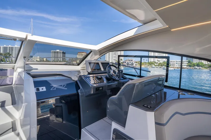 Slide: The Image of Cockpit of 2025 NX Boats NX41 HORIZON, featuring modern controls and waterfront view. - 3