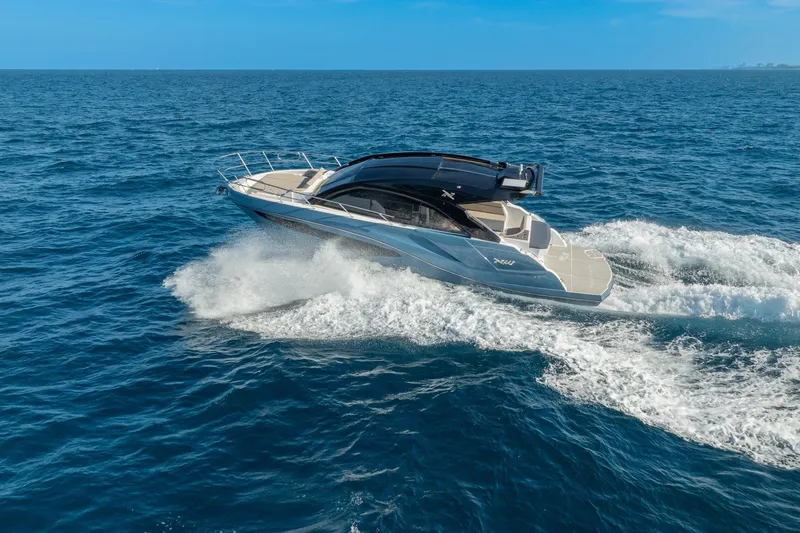 Slide: The Image of 2025 NX Boats NX41 HORIZON cruising on open sea under clear blue sky. - 30