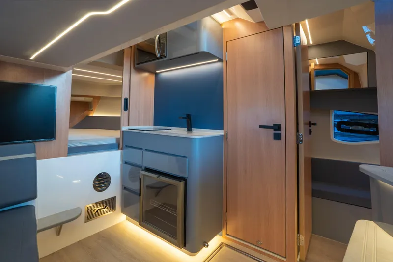 Slide: The Image of Modern interior of 2025 NX Boats NX41 HORIZON, featuring sleek kitchen and cozy sleeping area. - 4