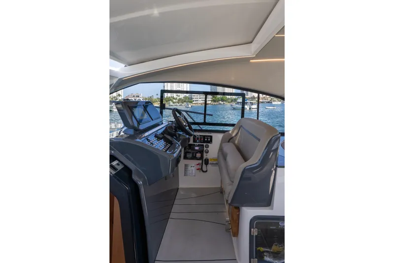 Slide: The Image of Interior view of 2025 NX Boats NX41 HORIZON helm with modern controls and waterfront backdrop. - 41
