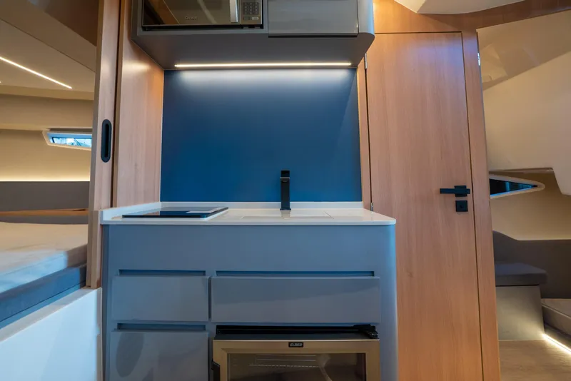 Slide: The Image of Modern interior of 2025 NX Boats NX41 HORIZON, featuring sleek kitchenette design. - 45