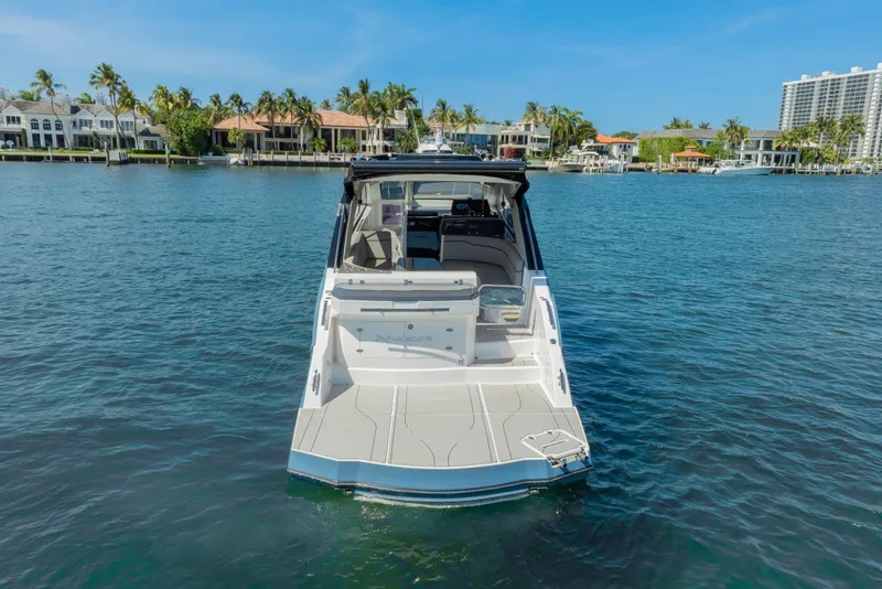 Slide: The Image of 2025 NX Boats NX41 HORIZON on serene water with luxury waterfront homes in background. - 8