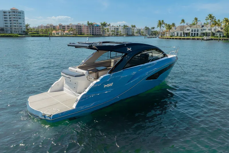 Slide: The Image of 2025 NX Boats NX41 HORIZON yacht on serene water with luxury waterfront backdrop. - 9