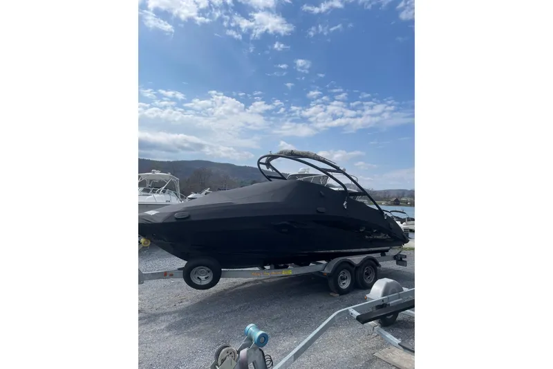 The Image of 2014 Yamaha Boats 242 Limited on trailer under a partly cloudy sky. - 1
