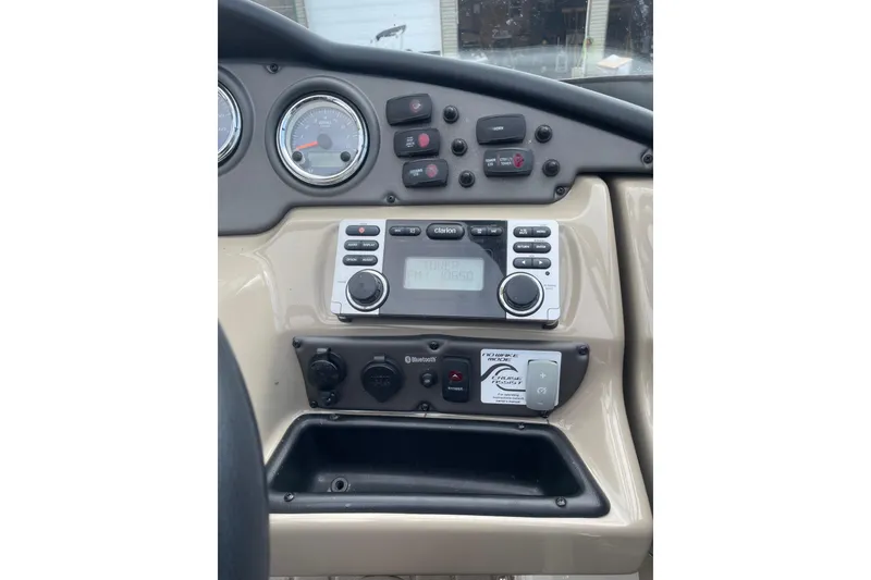 Slide: The Image of Dashboard of 2014 Yamaha Boats 242 Limited with controls and gauges. - 12