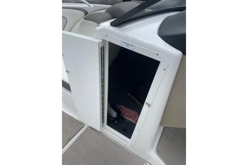 Slide: The Image of Open storage compartment on a 2014 Yamaha Boats 242 Limited. - 19
