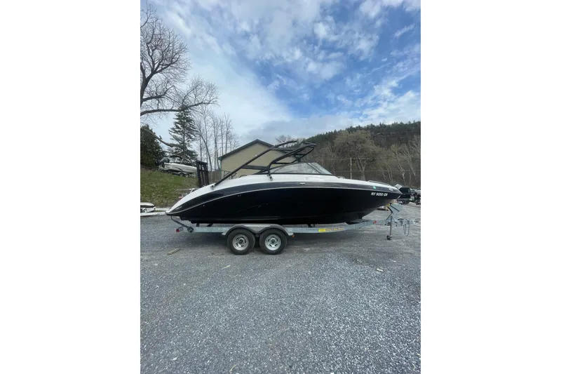 Slide: The Image of 2014 Yamaha Boats 242 Limited on trailer, parked outdoors under cloudy sky. - 3