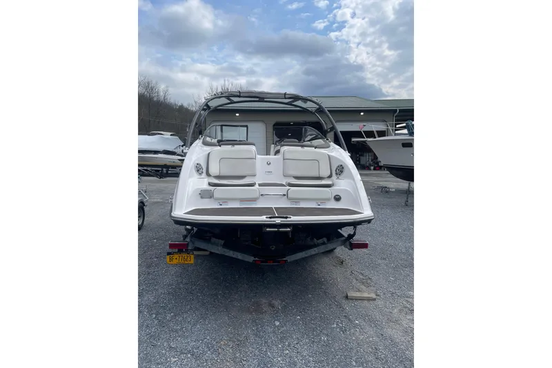 Slide: The Image of 2014 Yamaha Boats 242 Limited on trailer, rear view, parked outdoors. - 4