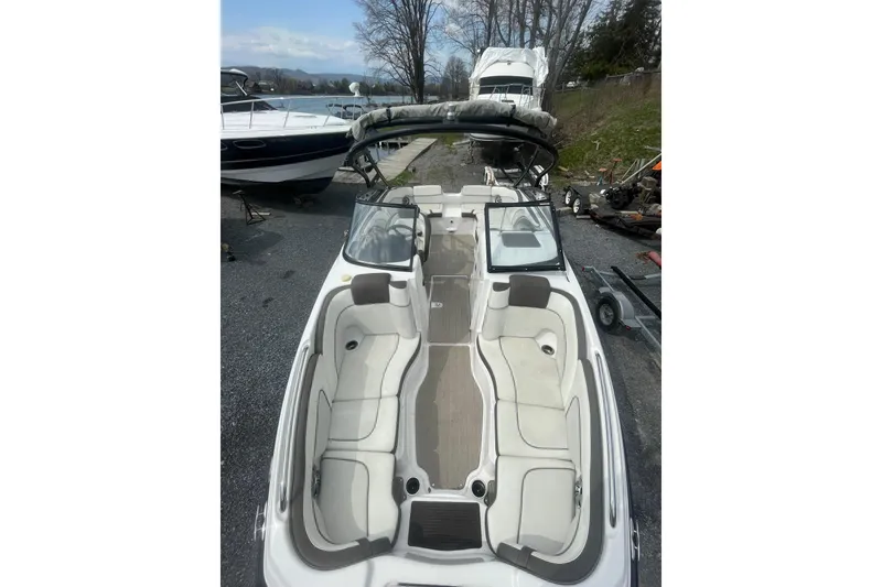 Slide: The Image of 2014 Yamaha Boats 242 Limited, spacious interior, docked outdoors, ready for adventure. - 6