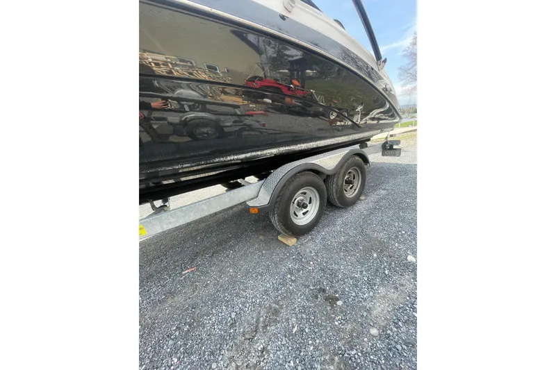 Slide: The Image of 2014 Yamaha Boats 242 Limited on trailer, parked on gravel surface. - 8