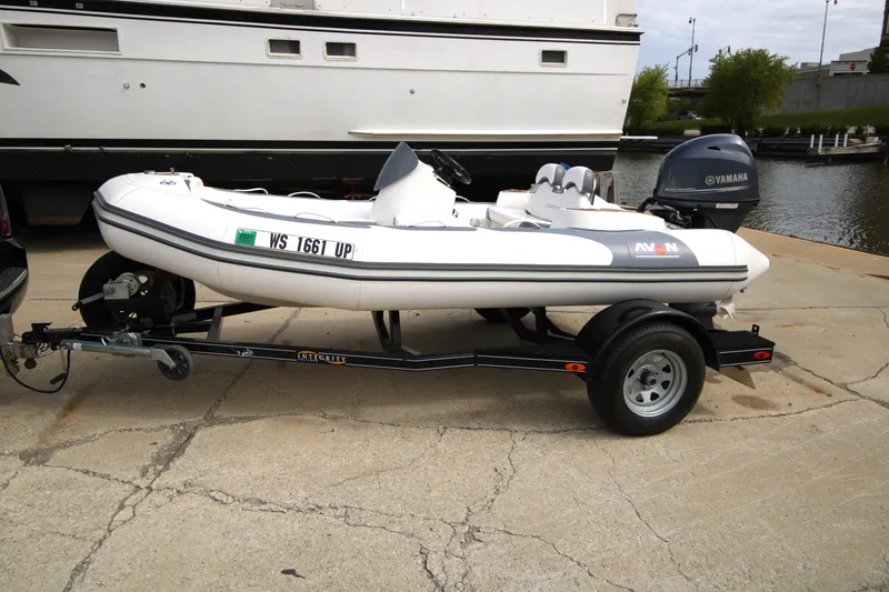 The Image of 2018 Avon Seasport 400 Deluxe NEO boat with 50hp Yamaha engine on trailer. - 1