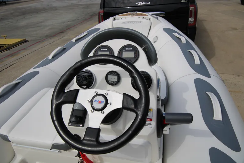 Slide: The Image of 2018 Avon Seasport 400 Deluxe NEO boat dashboard with steering wheel and controls. - 12