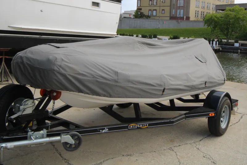 Slide: The Image of Covered 2018 Avon Seasport 400 Deluxe NEO 50hp on trailer by waterfront. - 14