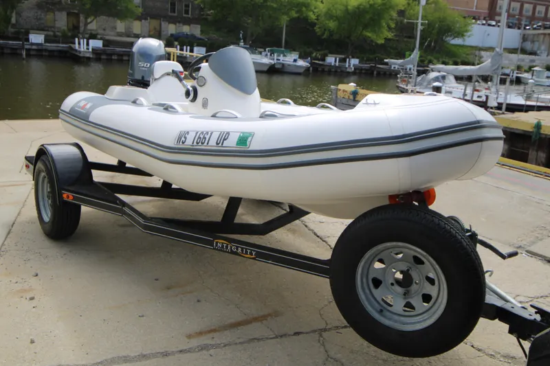 Slide: The Image of 2018 Avon Seasport 400 Deluxe NEO 50hp boat on trailer by waterfront. - 5