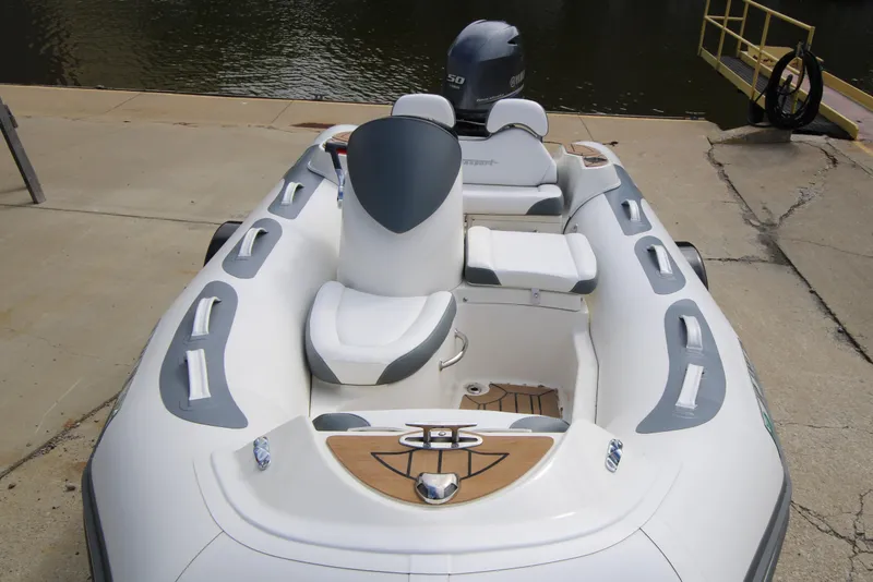 Slide: The Image of 2018 Avon Seasport 400 Deluxe NEO boat with 50hp engine, docked by the water. - 6