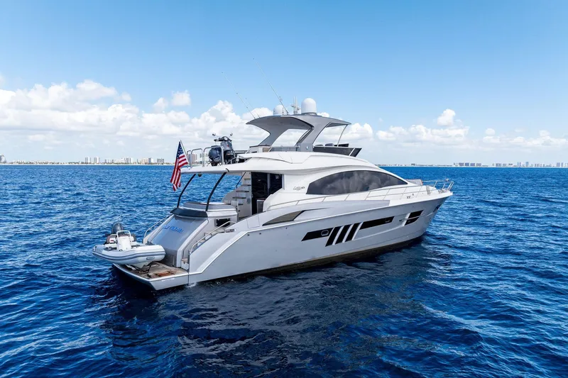 Slide: The Image of 2014 Lazzara 64 yacht cruising on open blue ocean under clear skies. - 2