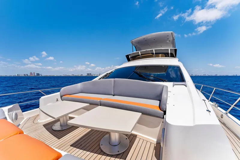 Slide: The Image of Luxurious 2014 Lazzara 64 yacht with spacious deck seating, cruising on open sea. - 20