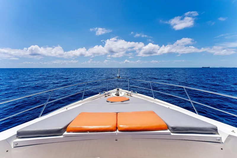 Slide: The Image of Bow view of 2014 Lazzara 64 yacht cruising on open sea under clear blue sky. - 23