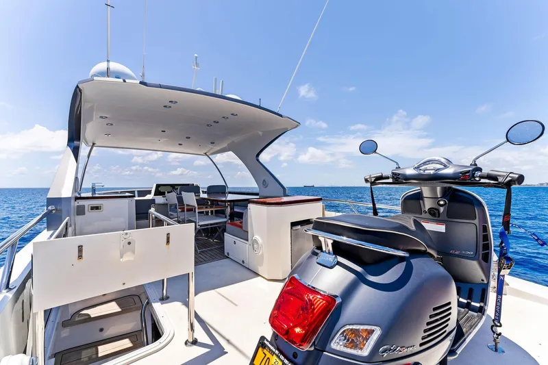 Slide: The Image of Luxurious 2014 Lazzara 64 yacht deck with scooter, ocean view, and modern amenities. - 27
