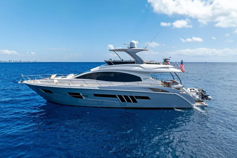 Slide: The Image of Luxury 2014 Lazzara 64 yacht cruising on open blue sea under clear sky. - 3